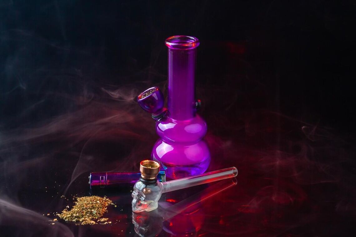 composition-smoking-accessories-with-pipe-pile-weed-purple-glass-bong-still-life_274234-16405