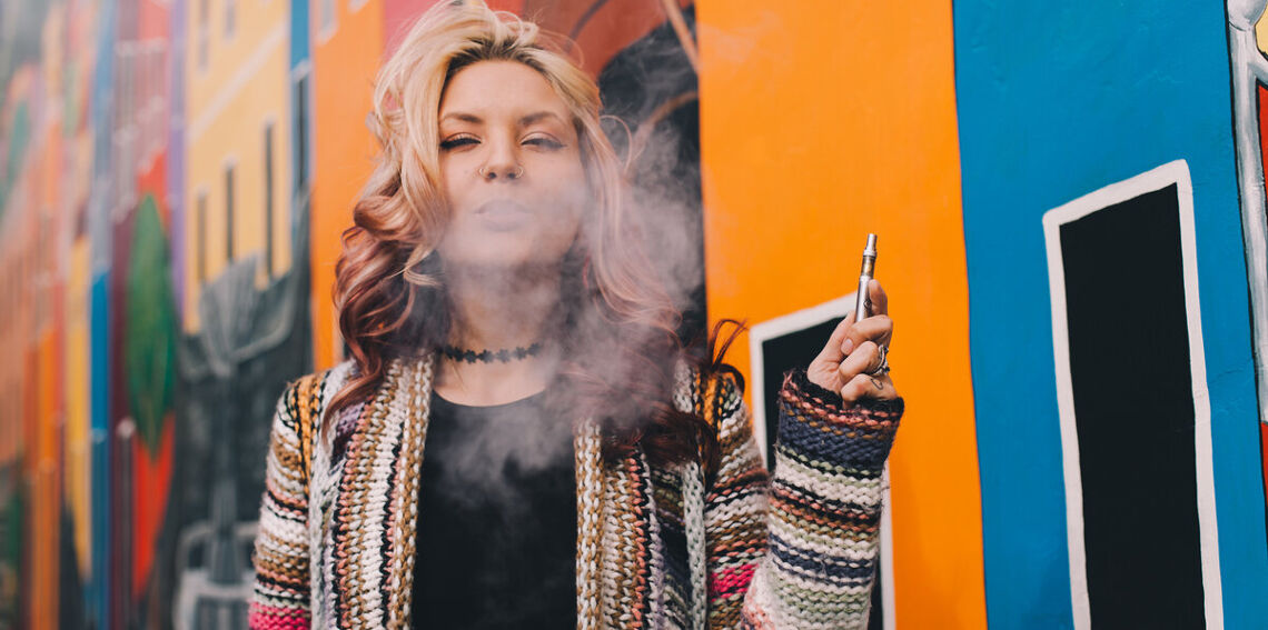 woman smoking with vape pen